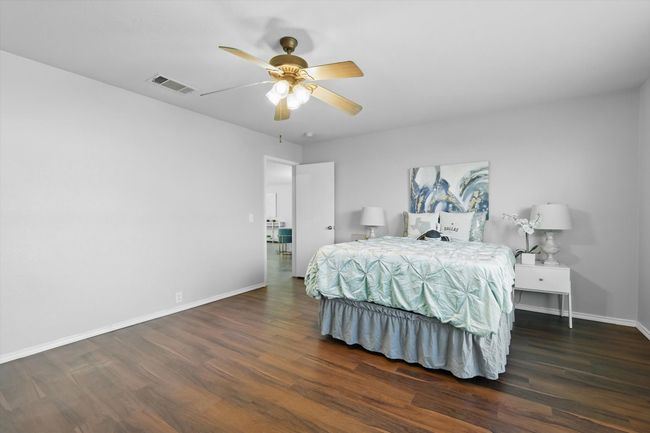 Bedroom featuring dark wood finished floors and ceiling fan | Image 18