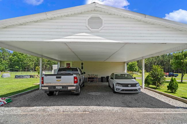 View of parking / parking lot with gravel driveway and an attached carport | Image 18