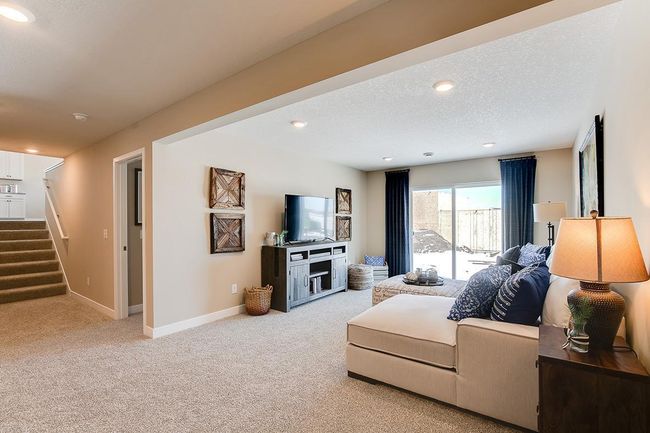 The lower level family room - comes FINISHED! Model home photo, colors and selections may vary. | Image 15