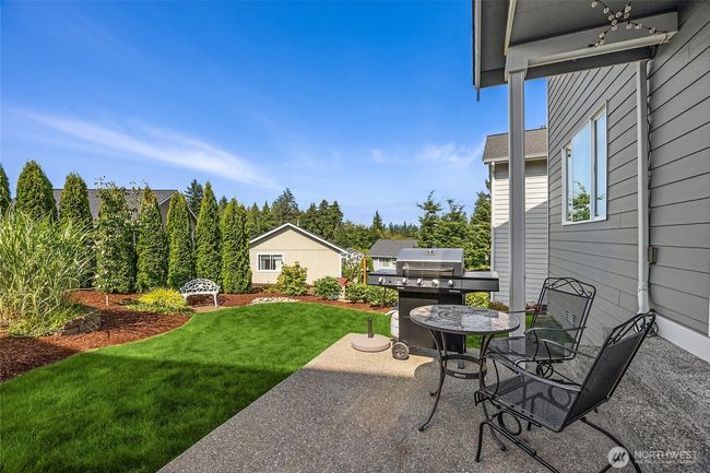 Backyard features a lush and level lawn space | Image 28