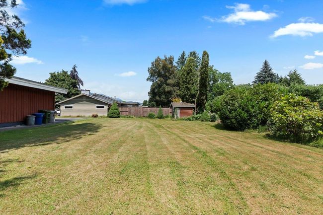 View of yard with a storage unit | Image 9