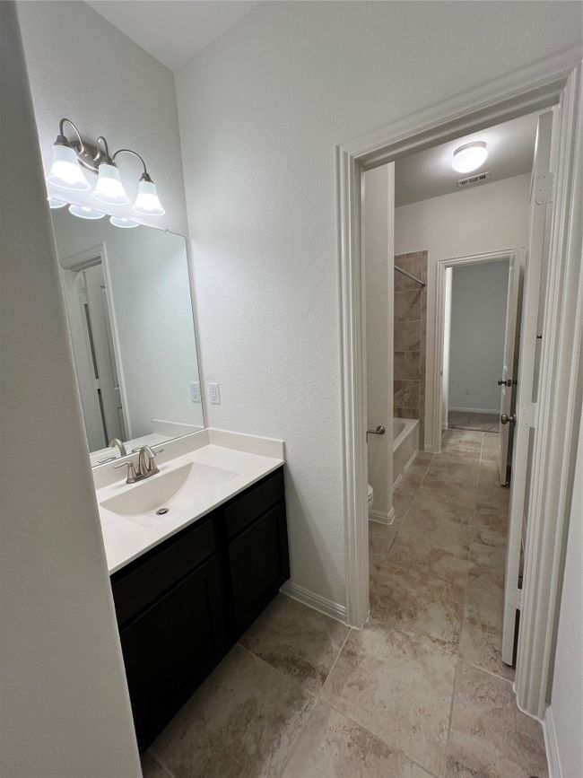Full bath featuring vanity and bathing tub / shower combination | Image 23