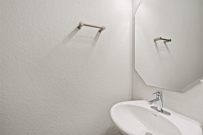 Bathroom featuring a sink and a textured wall | Image 32