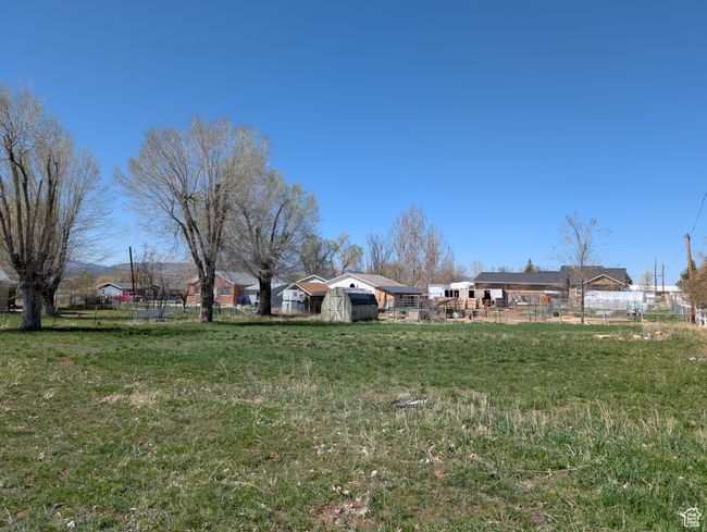 View of yard featuring an outbuilding and fence | Image 6