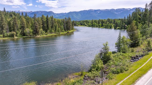 Water view featuring a heavily wooded area and a mountain backdrop | Image 54