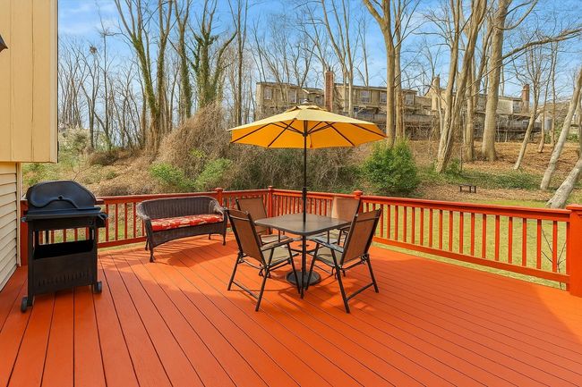Wooden deck with outdoor dining area and a grill. Digitally enhanced | Image 40