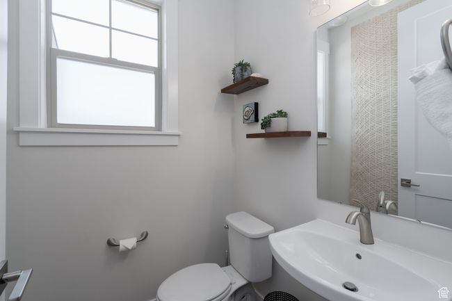 Bathroom with a sink, toilet, and healthy amount of natural light | Image 24