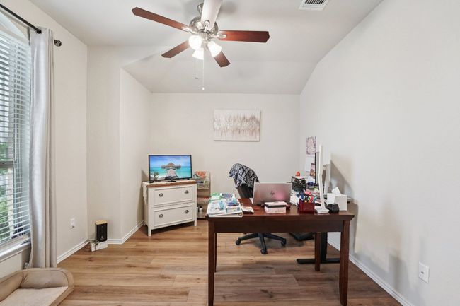 Home office featuring lofted ceiling, light wood-style floors, and ceiling fan | Image 14