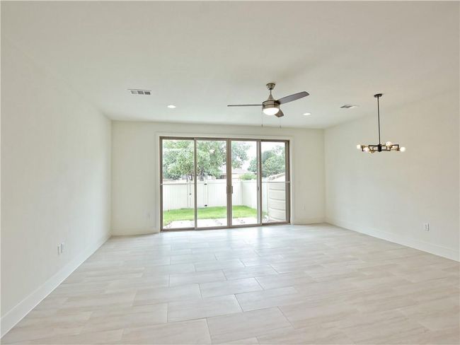 Spare room featuring a ceiling fan, a chandelier, and recessed lighting | Image 6