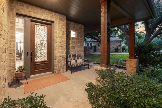 Entrance to property with stone siding and covered porch | Image 26