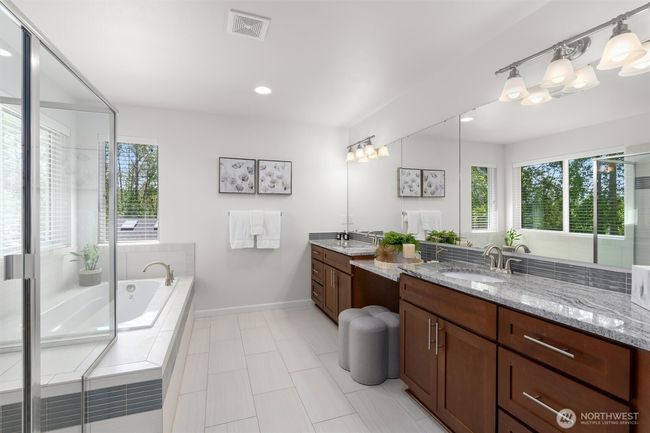 Spa-inspired primary bathroom complete with a double sink vanity, soaking tub, walk-in shower and separate toilet room! | Image 21