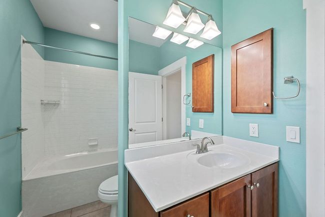 Full bath featuring vanity, shower combination, and tile patterned flooring | Image 6