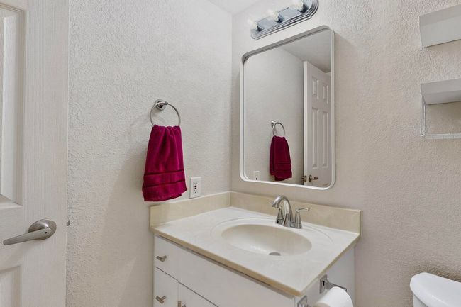 Half bathroom with a textured wall and vanity | Image 22