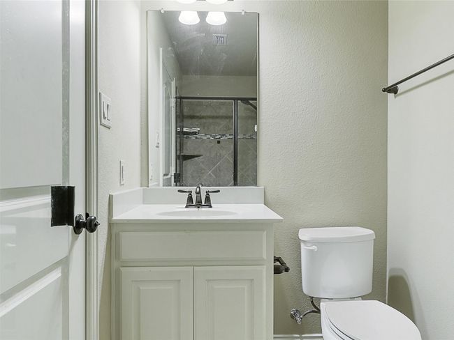 Bathroom with vanity and a textured wall | Image 29