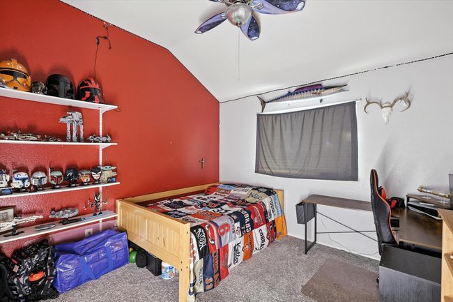 Bedroom featuring lofted ceiling, carpet floors, and a ceiling fan | Image 13