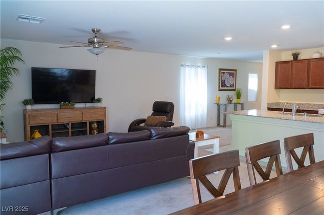 Living area with recessed lighting, visible vents, light colored carpet, and ceiling fan | Image 32