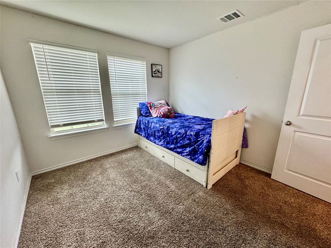 Bedroom featuring carpet flooring, multiple windows, and baseboards | Image 10