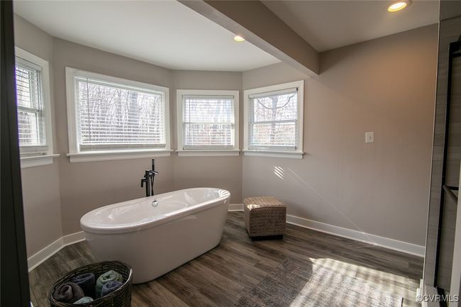 Full bath featuring a soaking tub, recessed lighting, wood finished floors, and baseboards | Image 31