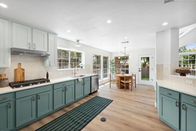 Dual toned cabinetry, large single basin sink, and brand new appliances. | Image 9