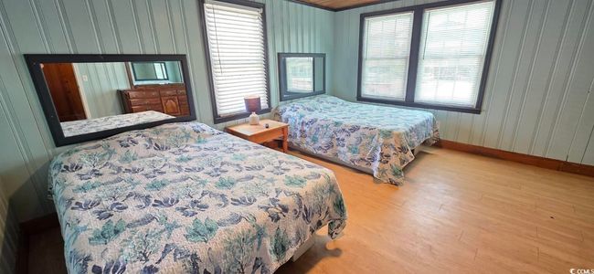 Bedroom featuring wood finished floors and multiple windows | Image 27