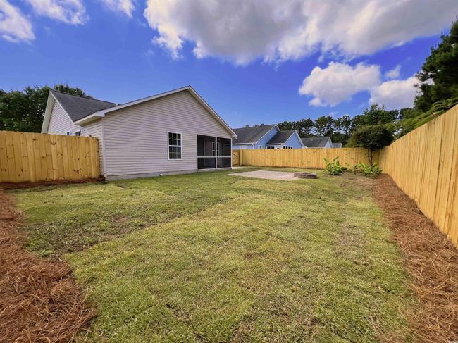 Fenced backyard with a sunroom and a patio | Image 11