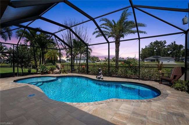 Pool at dusk with a patio area, an outdoor pool, and a lanai | Image 39