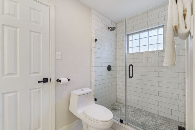 Full bathroom with baseboards, a stall shower, and toilet | Image 24