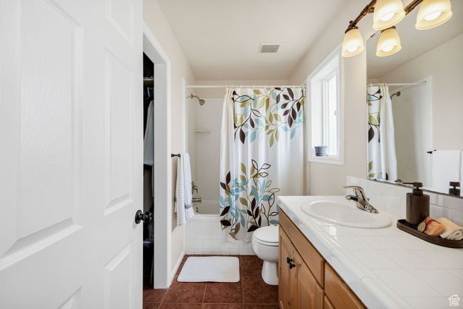 Master Bathroom with vanity, shower / tub combo, tile patterned flooring, and toilet & Walk In Closet | Image 11