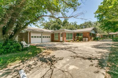 Ranch-style home with a garage and central air condition unit | Image 3