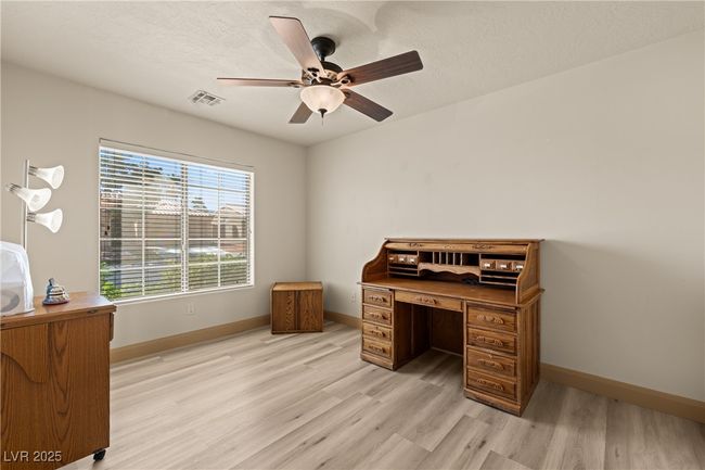 Office area featuring light wood-style flooring, a ceiling fan, and a textured ceiling | Image 7