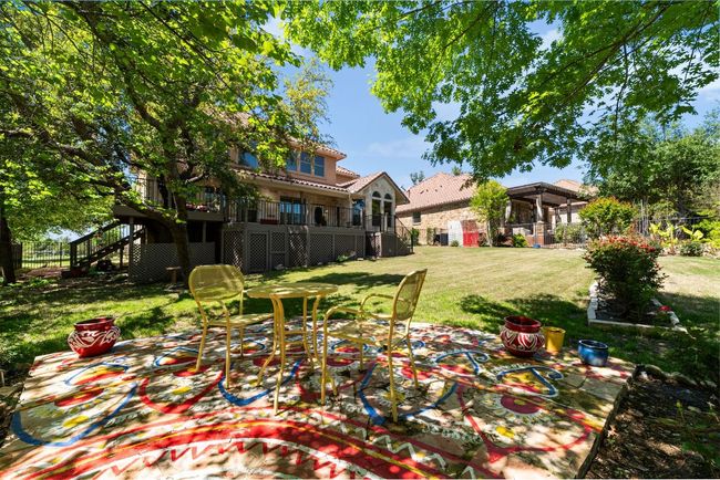 View of yard with stairs, a wooden deck, and a patio | Image 29