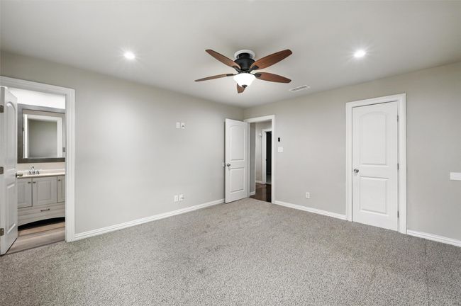Unfurnished bedroom with carpet, baseboards, ensuite bath, and recessed lighting | Image 7