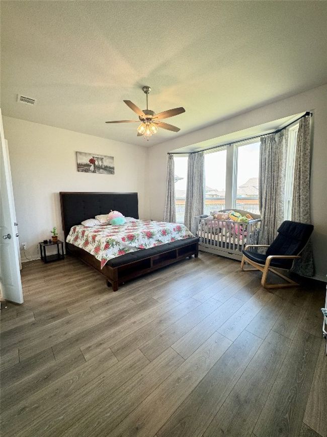 Bedroom with wood finished floors and a ceiling fan | Image 21