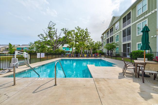 Community pool with a residential view and fence | Image 38