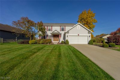 View of front of home featuring covered porch, a garage, and a front lawn | Image 2