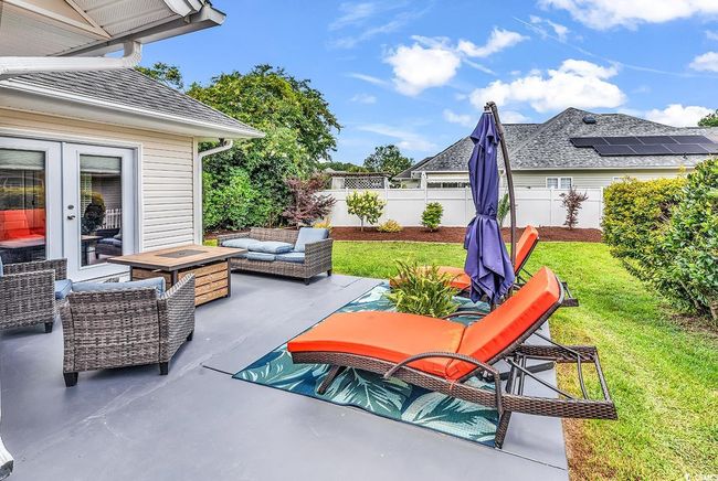 Fenced backyard with an outdoor living space and a patio area | Image 14