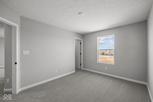 unfurnished room featuring carpet, baseboards, and a textured ceiling | Image 9