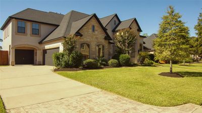 Freshly painted exterior, all stucco and stone, no wood, making it maintenance free. Large front yard with lush landscaping and 2 oak trees added last year. | Image 3