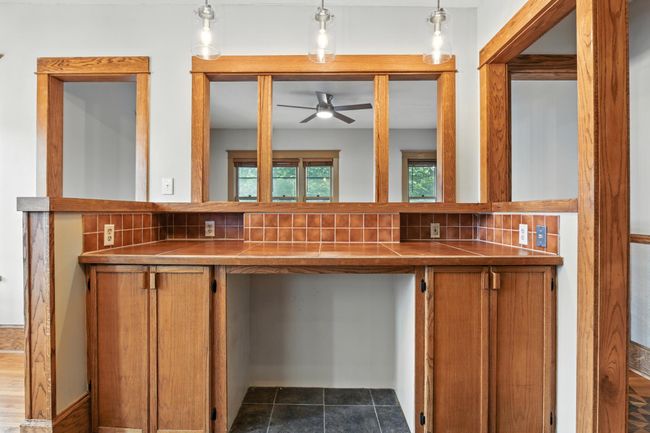 Close-up of tiled breakfast bar with pendant lighting, ideal for casual dining or serving guests. | Image 16
