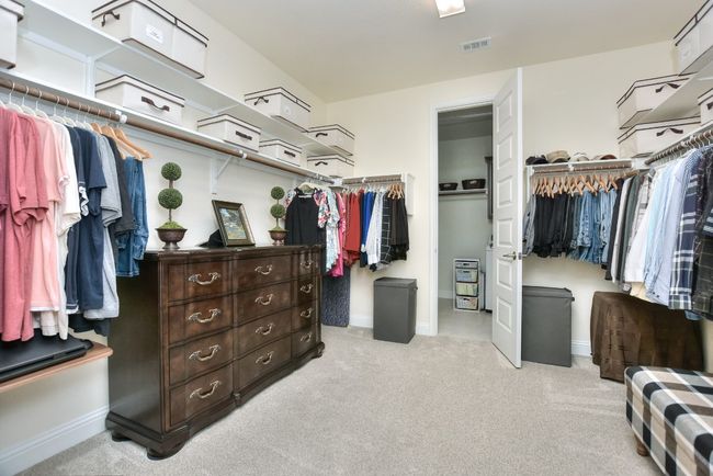 Walk in closet featuring visible vents and carpet flooring | Image 27