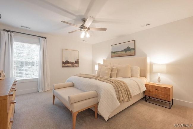Bedroom with light carpet and ceiling fan | Image 38