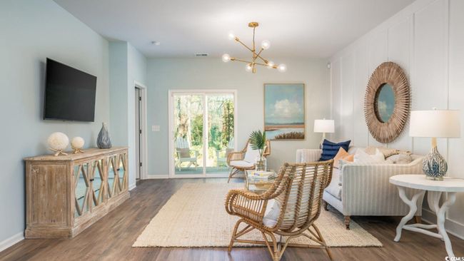 Living area with a chandelier and wood finished floors | Image 16