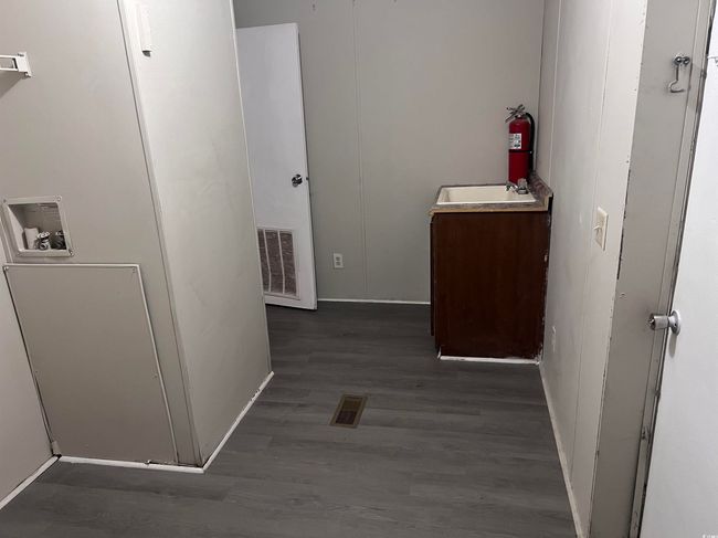 Hallway featuring wood finished floors and a sink | Image 15