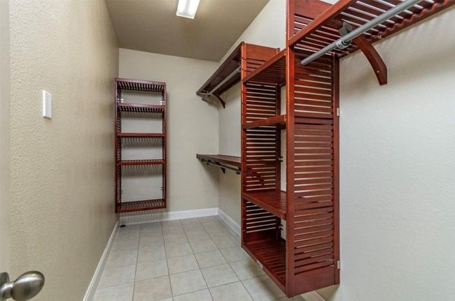 Walk in closet with tile patterned flooring | Image 17