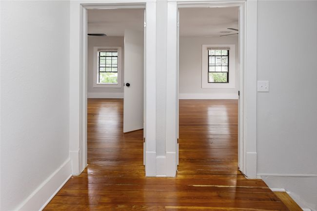Corridor featuring hardwood / wood-style flooring, healthy amount of natural light, and baseboards | Image 23