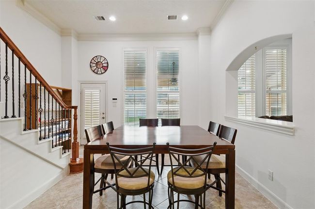 Breakfast area just to the side of the living room and kitchen. Leads to back yard and 2nd staircase to the upstairs. | Image 15