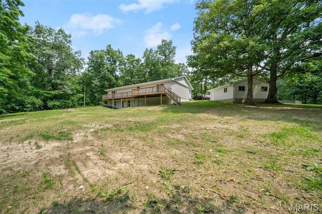 View of grassy yard featuring a wooden deck and stairs | Image 53