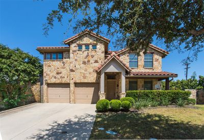 Mediterranean / spanish home featuring a garage and a front lawn | Image 1