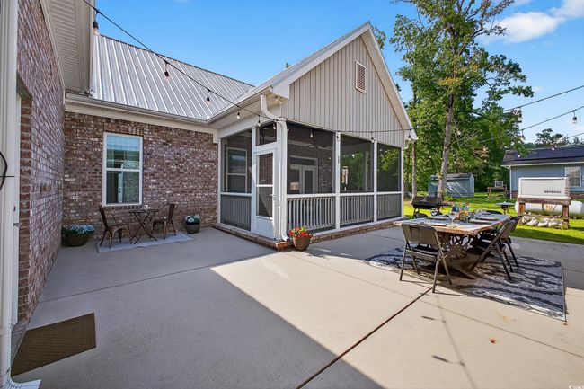 View of patio / terrace featuring outdoor dining space, a sunroom, and a grill | Image 37