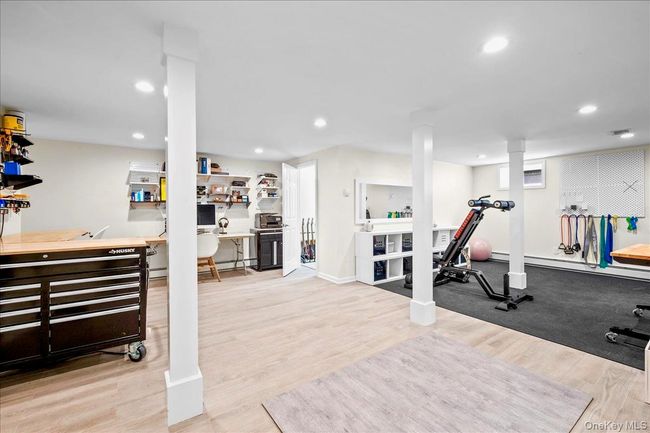 Workout area with wood finished floors, recessed lighting, and a baseboard heating unit | Image 30